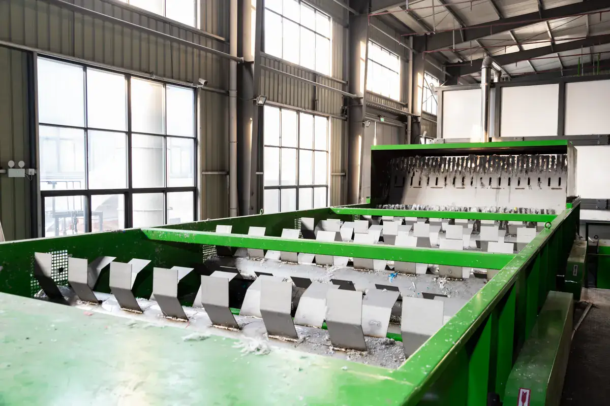 A float-sink tank in one of our film lines: PE film floats while stones and heavy dirt sink. Float-sink washing tank with paddles in a film washing line