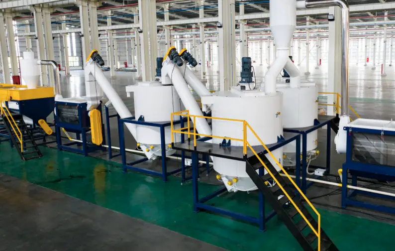 Insulated hot-wash tanks with screw conveyors and dosing equipment in a PET washing plant